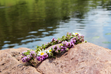 A wreath of wild flowers lying on the stone