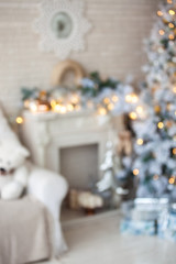 Modern white tree decorated in christmas toys defocused with bokeh effect. Merry christmas and new year background.