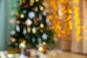 Classic green tree decorated in christmas toys defocused with bokeh effect. Merry christmas and new...