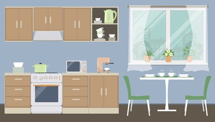 Kitchen in a blue color. There is a kitchen furniture of a beige color, a table, two green chairs, a kettle, a microwave, a coffee machine and other objects in the picture. Vector flat illustration