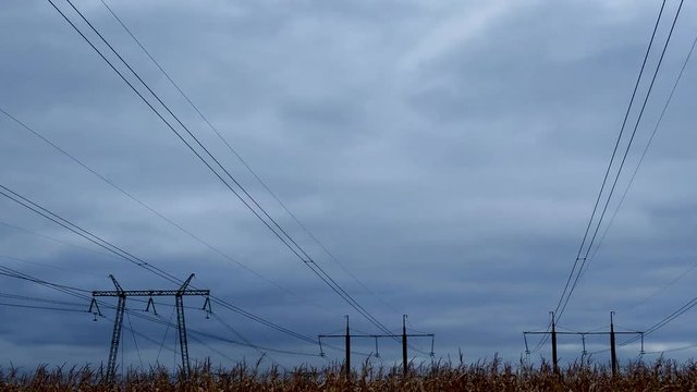 Timelapse video running clouds over high voltage power line