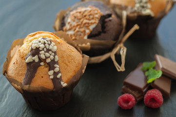 three muffin with raspberries and chocolate