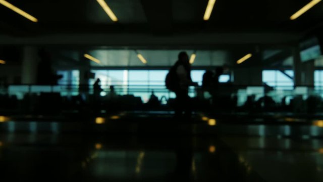 slightly blurred video crowd of people, transferred to a large airport terminal, awaiting your flight