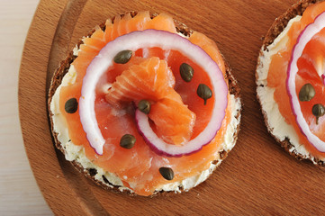 sandwiches with butter and red fish, red onion and capers on woo