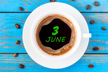 June 3rd. Day of the month 3 , everyday calendar written on morning coffee cup at blue wooden background. Summer concept, Top view