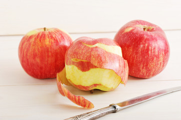 Apple with purified skin and a knife