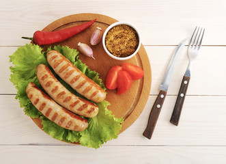 Bavarian sausages grilled on a wooden round Board
