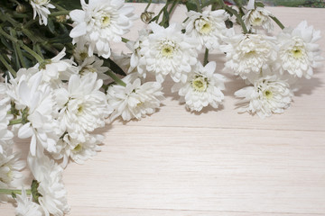 group of white flower on wooden desk,white flower have green leaf,green leaf make oxygen,copy space