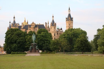 Fototapeta na wymiar Castle garden and Statue Frederick Francis II with view to Schwerin Castle, Mecklenburg Germany 