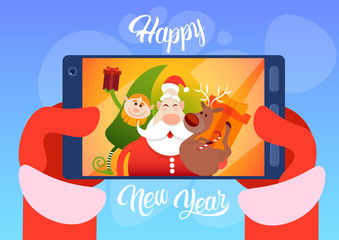 Fototapeta premium Santa Claus With Reindeer Elfs Making Selfie Photo, New Year Christmas Holiday Greeting Card Flat Vector Illustration
