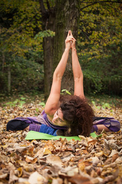 young woman practice yoga outdoor autumn
