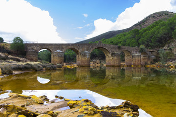 Roman Bridge with reflections in Odiel River, Huelva, Andalusia, Spain