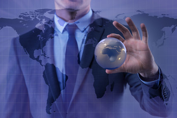 Businessman holding globe in global business concept