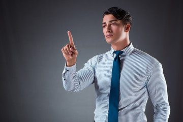Handsome businessman pressing virtual buttons