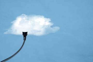 Electric plug with cable connect with the cloud over blue background. Cloud computing concept