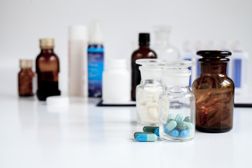glass jars of pills - home first aid kit