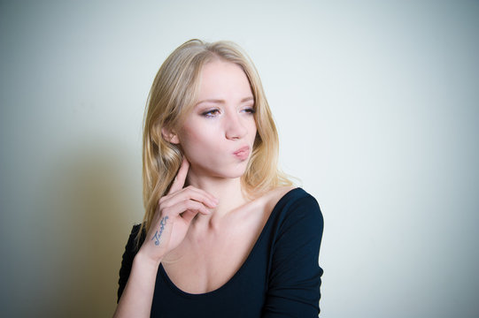 Thoughtful young blonde woman portrait