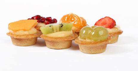 pastry tartlets with fresh fruit isolated on white background