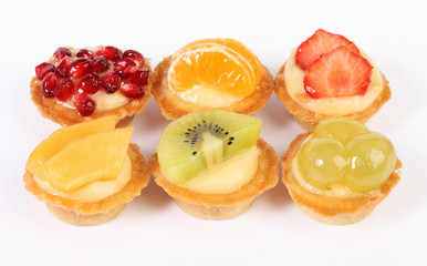 pastry tartlets with fresh fruit isolated on white background