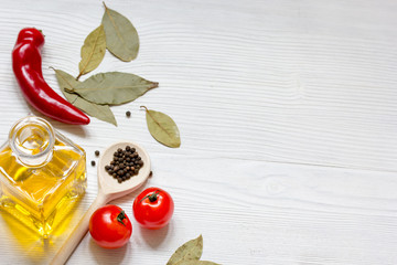 oil with spices and chilli on wooden background