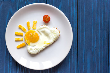 sunshine fried eggs breakfast for kid on blue background