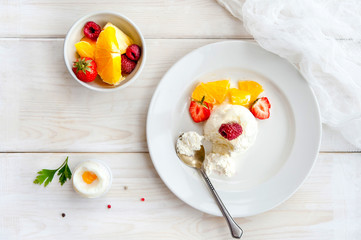 Ice cream with berries on white plate top view
