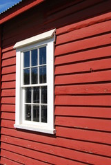 Fototapeta premium Red Barn and White trim Window Farm fields, equipment, buildings