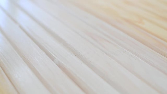 Worker's hand holding brush and painting white on wood fence. Full HD 1080p