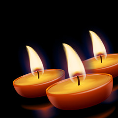 three candles in darkness
