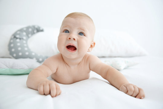 Portrait of little baby on bed