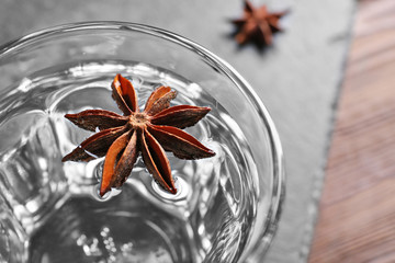 Vodka with anise on table closeup