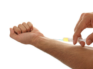 Muscular man injecting steroids on white background