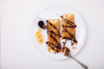 Pancakes with banana and chocolate topping.selective focus.