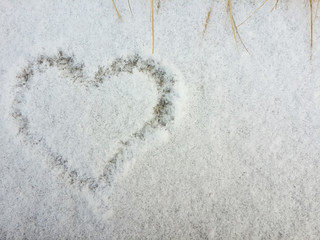 Drawing heart shape on the snow background