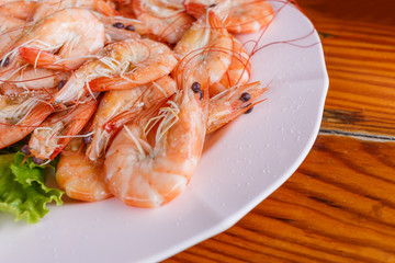 Baked butter shrimp on white dish