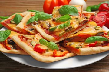 Delicious pizza slices on plate