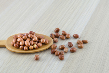 Salted peanut on wooden spoon