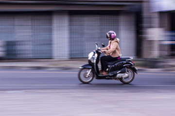 Fototapeta na wymiar motorcycle panning in road, Asia