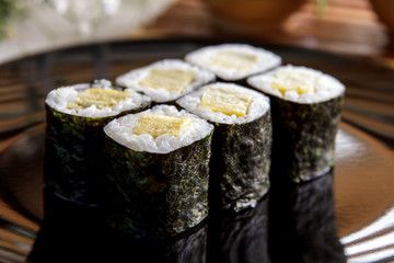 japanese food tamago maki sushi on black plate © Odua Images