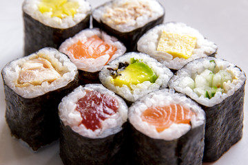 various of maki sushi on white plate