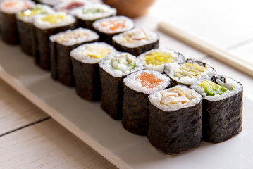 japanese food mini maki sushi platter on white wooden table