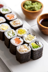 japanese food mini maki sushi platter on white wooden table