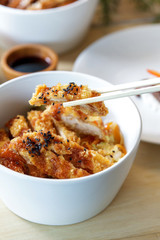 japanese food chicken katsu don served in white bowl with chopst