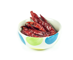 Dried red chili pepper in cup on white background
