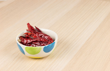 Dried red chili pepper on wooden table