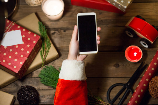 Santa use smart phone mock up with a copyspace for Christmas.Chr