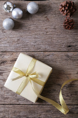 Present on wooden surface with christmas decoration
