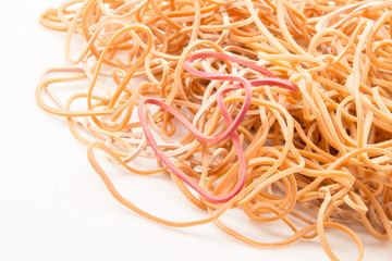 Rubber bands in a pile on a white background.
