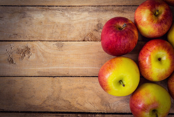 red apple on wood background texture with space for text