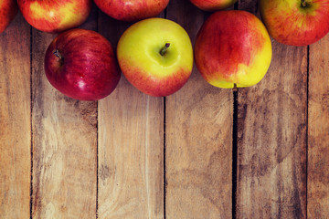 red apple on wood background texture with space for text